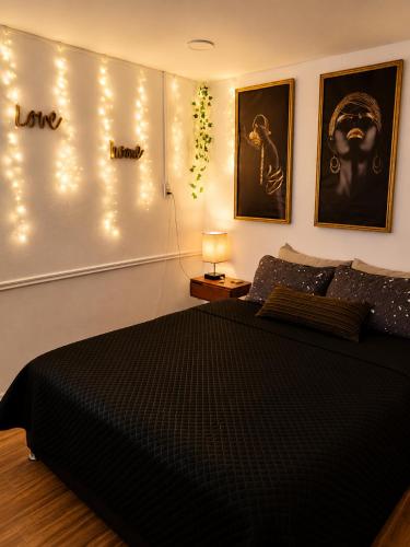 a bedroom with a bed with lights on the wall at Yui Loft cómodo para pareja o estancia tranquila in Pachuca de Soto
