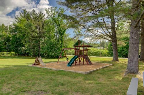a playground in a park with two swings at Charming and casual motel in a great location with shared resort amenities in Lincoln