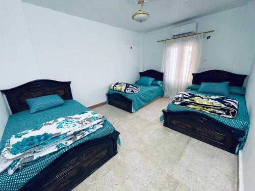 a bedroom with two beds and a window at شقق قرية النورس in Ismailia