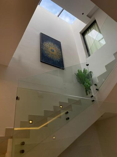 a glass stair case with a painting on it at الدغيثر للشقق المخدومه in Ash Shafa