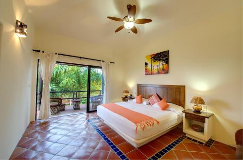a bedroom with a bed and a ceiling fan at Las Palmas Oceanfront Villas and Casitas in Santa Cruz Huatulco