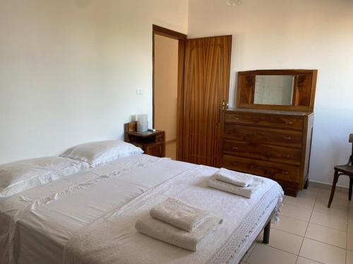 a bedroom with a bed with two towels on it at Terrazzo Vista Mare Mozzafiato in Cariati