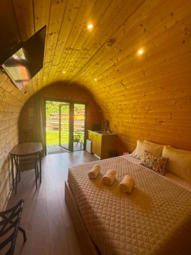 a bedroom with a large bed with a wooden ceiling at Gerês Wood Valley in Geres