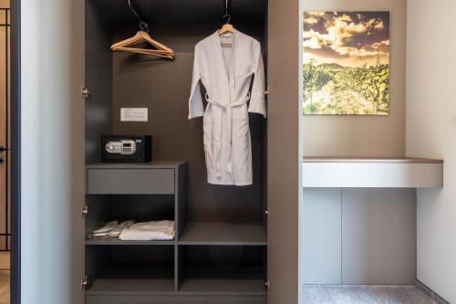 a dressing room with a white robe hanging on a wall at Hotel Chateau Cojusna in Cojuşna