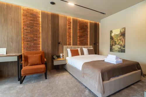a bedroom with a bed and a desk and a chair at Hotel Chateau Cojusna in Cojuşna