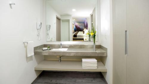 a bathroom with a sink and a mirror at Life Hotel in Oaxaca City