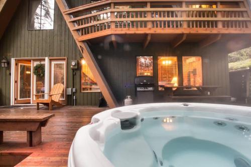 a jacuzzi tub in a room with a staircase at Forest View Chalet in Glacier