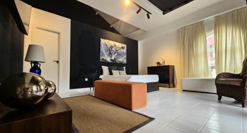 a living room with a bed and a couch in a room at Garden Suite in Oya