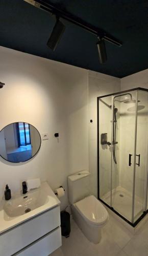 a bathroom with a shower and a toilet and a sink at Garden Suite in Oya