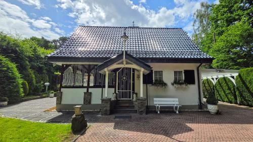 a small house with a bench in front of it at Villa Albert in Euskirchen