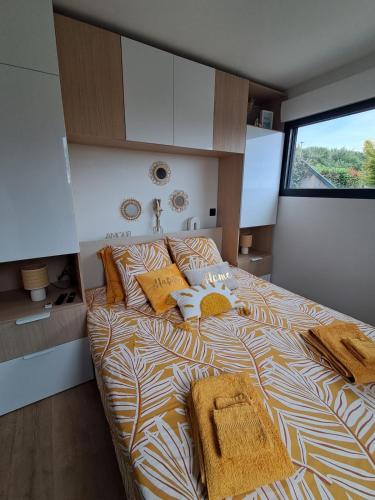a bedroom with a large bed with towels on it at Studio Cotentin Evas'yon in Feugères