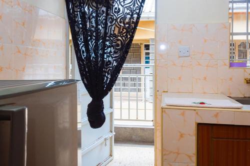 a kitchen with a curtain hanging over a counter at Cherve BnB in Nakuru
