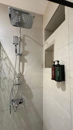 a shower in a bathroom with a shower head at Qubaa Soul Studio 2-3 in Medina