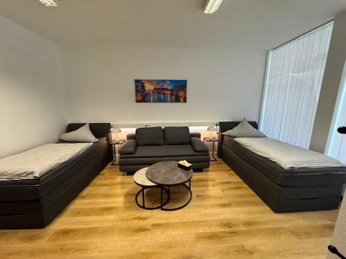 a living room with two couches and a table at City Apartment in Siegen