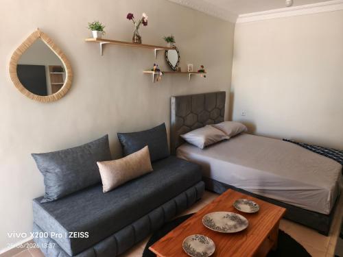 a room with a bed and a couch and a table at Studio avec terrasse privée sans vis-à-vis in Essaouira