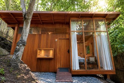 a cabin in the woods with a large glass door at Tití Bungalows in Tarapoto