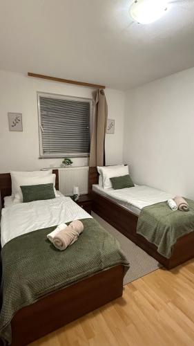 a bedroom with two beds with towels on them at The Nook Apartment in Jesenice