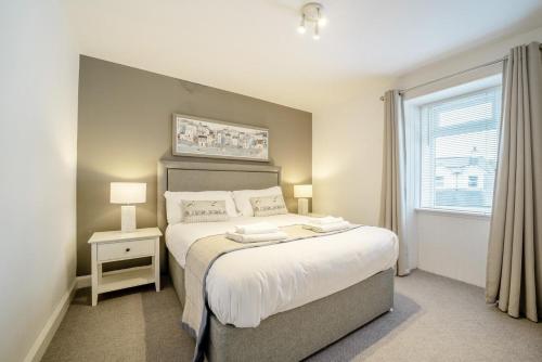 a bedroom with a large bed and a window at 2 Bed in Portpatrick oc-p43756 in Portpatrick