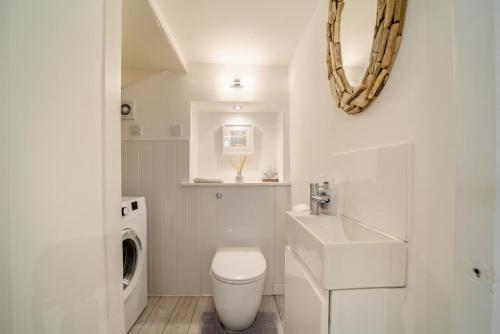 a white bathroom with a toilet and a sink at 2 Bed in Portpatrick oc-p43756 in Portpatrick