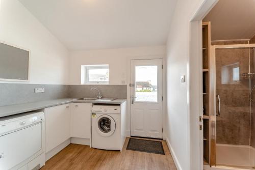 a white kitchen with a washer and dryer at 4 Bed in Portpatrick oc-p43755 in Portpatrick