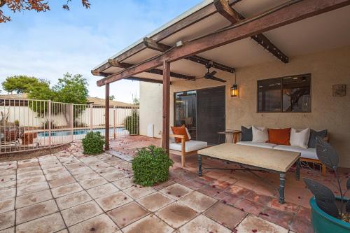 a patio with a couch and a bench on a patio at Hidden Bloom Sanctuary in Litchfield Park