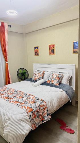 two beds sitting next to each other in a bedroom at Kaizen Homes in Homa Bay