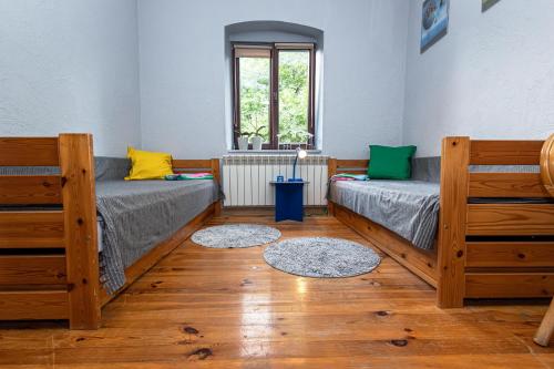 a room with two beds and a window at Pod lasem in Górowo Iławeckie