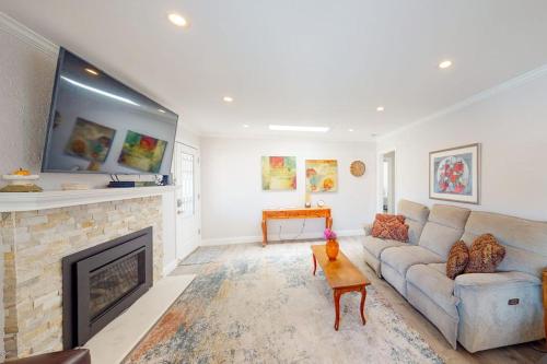 a living room with a couch and a fireplace at Portola Oasis - Permit DRO-STR-18 in Monterey
