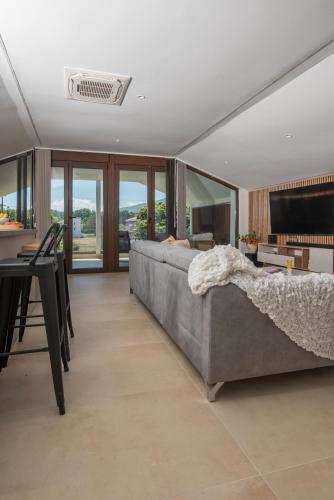 a bedroom with a large bed and a table and chairs at Zeusplace Olympus Casa in Paralía Skotínis