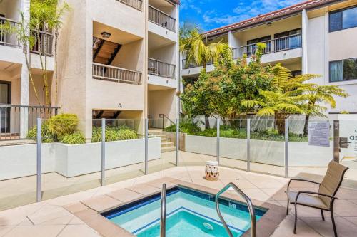 an apartment with a swimming pool and a building at Beach Retreat in Santa Barbara