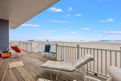 a deck with chairs and a view of the beach at Sand Side Bliss in Oxnard