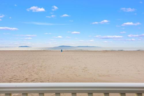 a view of a beach with a person in the distance at Sand Side Bliss in Oxnard