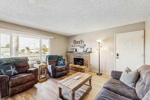 a living room with a couch and a fireplace at Ramona Memories in Grover Beach