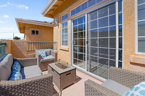 a patio with a couch and chairs on a balcony at Santo Tomas Getaway in Grover Beach