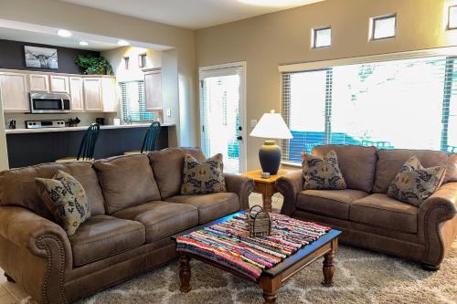 a living room with two brown couches and a table at Vistoso Resort Casita #163 in Oro Valley