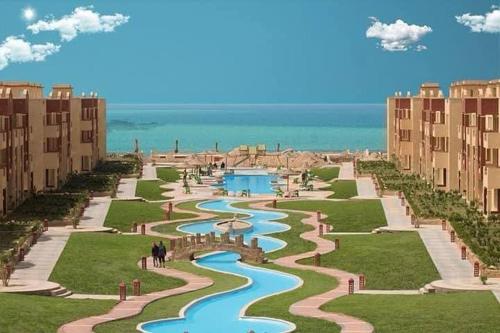 a view of a resort with a river and buildings at لاسيرينا عيون موسى LaSerinaللعائلات in Ras Sedr