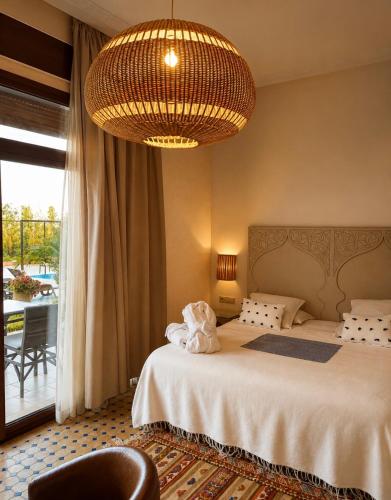 a bedroom with a bed and a chandelier at Dar Tanja in Tangier