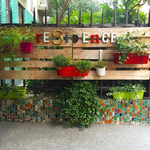 a wooden wall with potted plants on it at Residence Pian della Nave in Milan