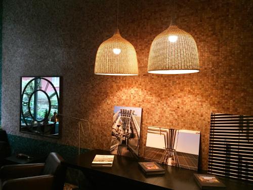 two pendant lights hanging over a table in a room at Residence Pian della Nave in Milan