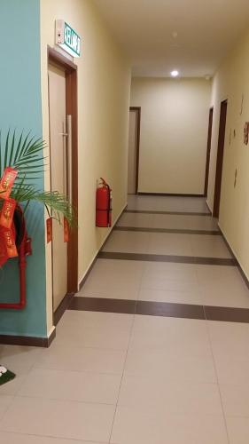 an empty hallway of a hospital with a sign on the wall at Mass Hotel in Kampong Kerayong