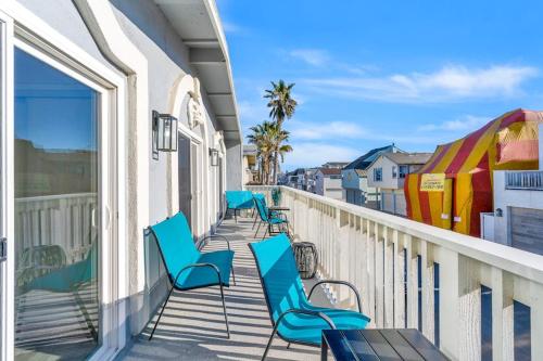 a row of blue chairs on a balcony at Seashore Dreams B - Upper Unit in Newport Beach