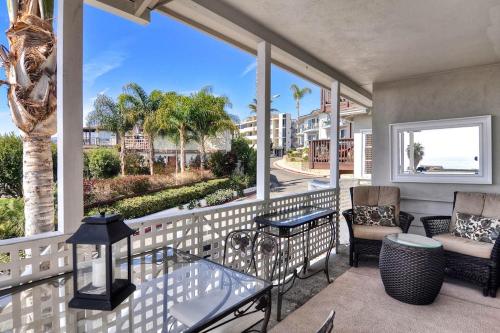 a balcony with a view of the ocean and palm trees at San Clemente - Monterey Fourplex in San Clemente