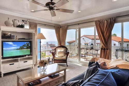 a living room with a person laying on a couch at San Clemente - Monterey Fourplex in San Clemente