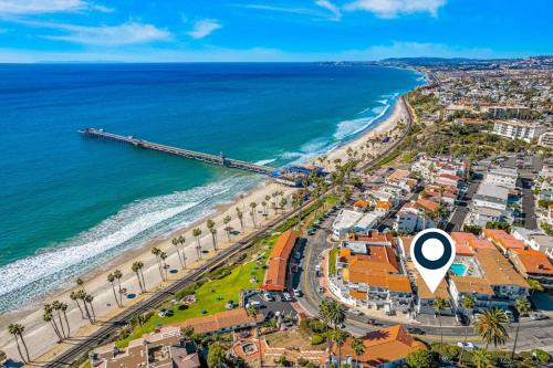 an aerial view of a beach with a pier at San Clemente Sunset in San Clemente