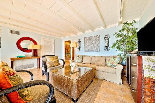 a living room with a couch and a table at Tommy Bahama Beach Rd II in Dana Point