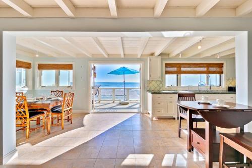 a dining room with a table and a view of the ocean at Tommy Bahama Beach Rd II in Dana Point