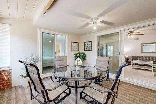 a dining room with a glass table and chairs at Evening Oasis in Orange