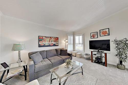a living room with a couch and a tv at Monarch Vista in Dana Point