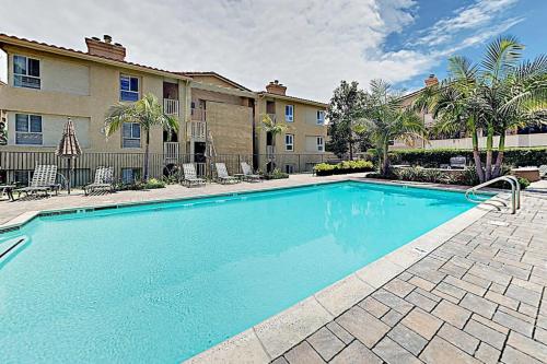 a large blue swimming pool in front of a building at Monarch Vista in Dana Point