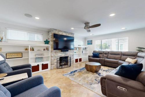 a living room with a couch and a fireplace at Palm Tree Getaway in Newport Beach